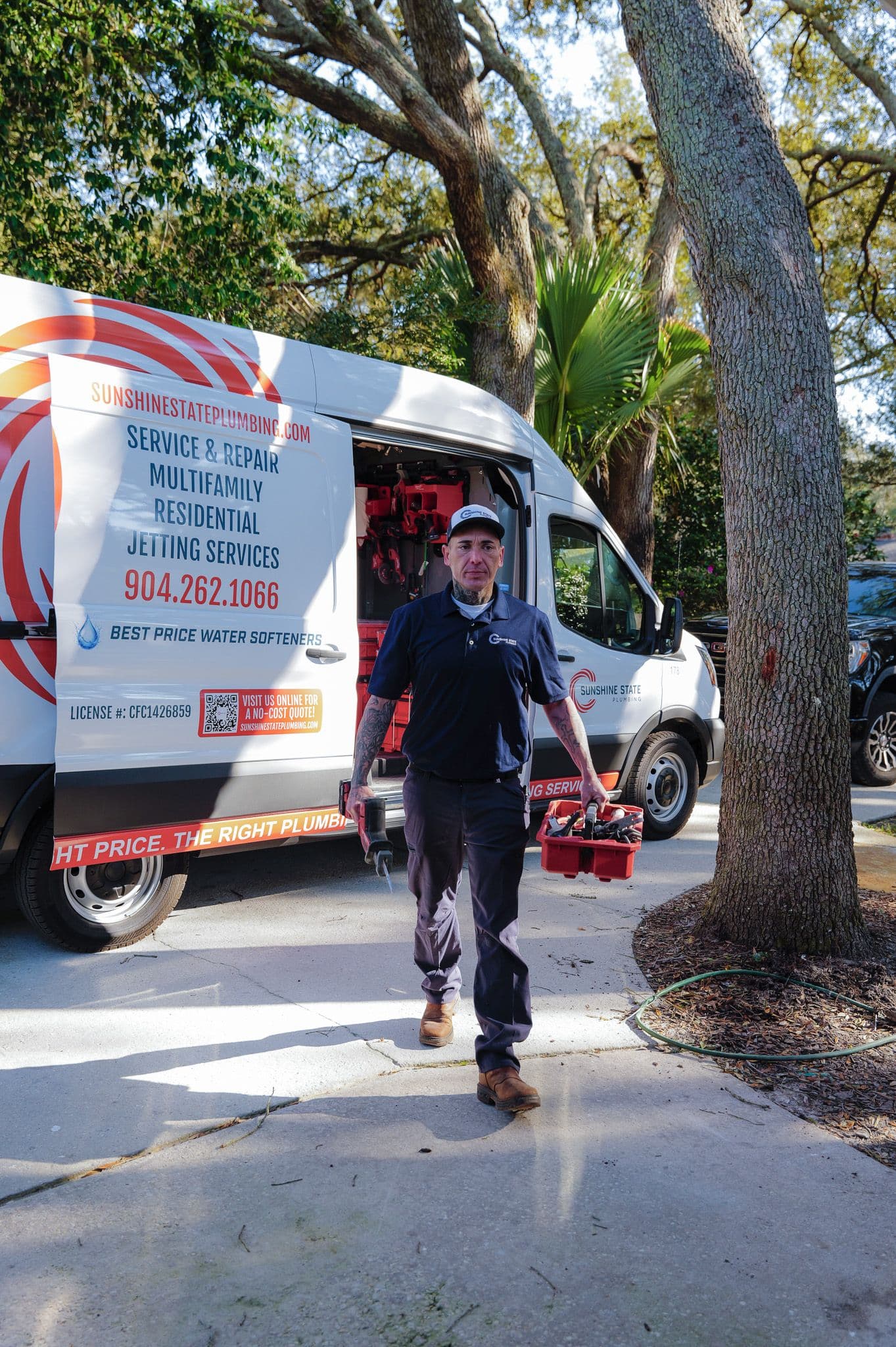 A Sunshine State Plumbing technician arriving from the van with tools for an emergency call