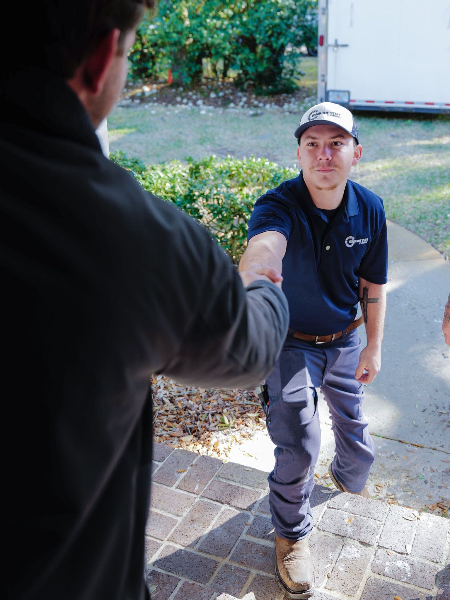Sunshine State Plumbing technician shaking hands with a Jacksonville customer