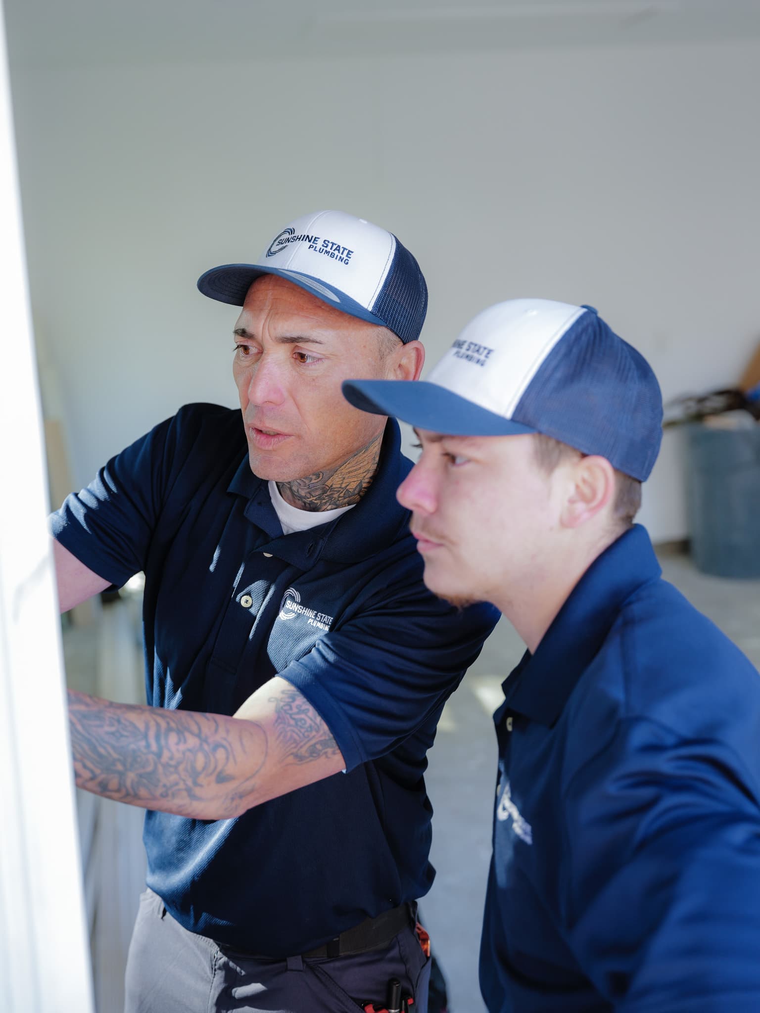 Two Sunshine State Plumbing technicians repiping a Jacksonville home