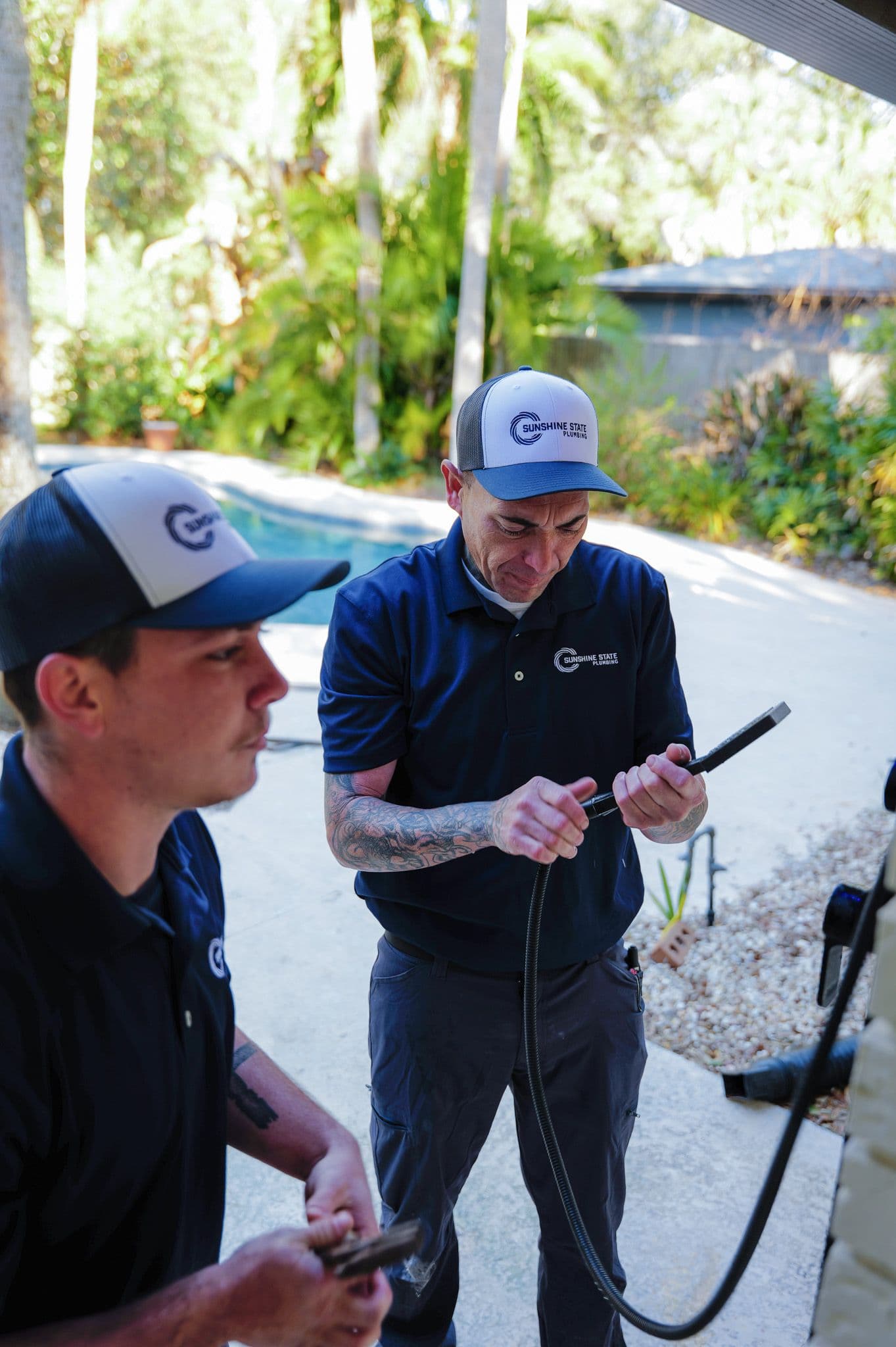 Two Sunshine State Plumbing technicians testing for a hidden leak