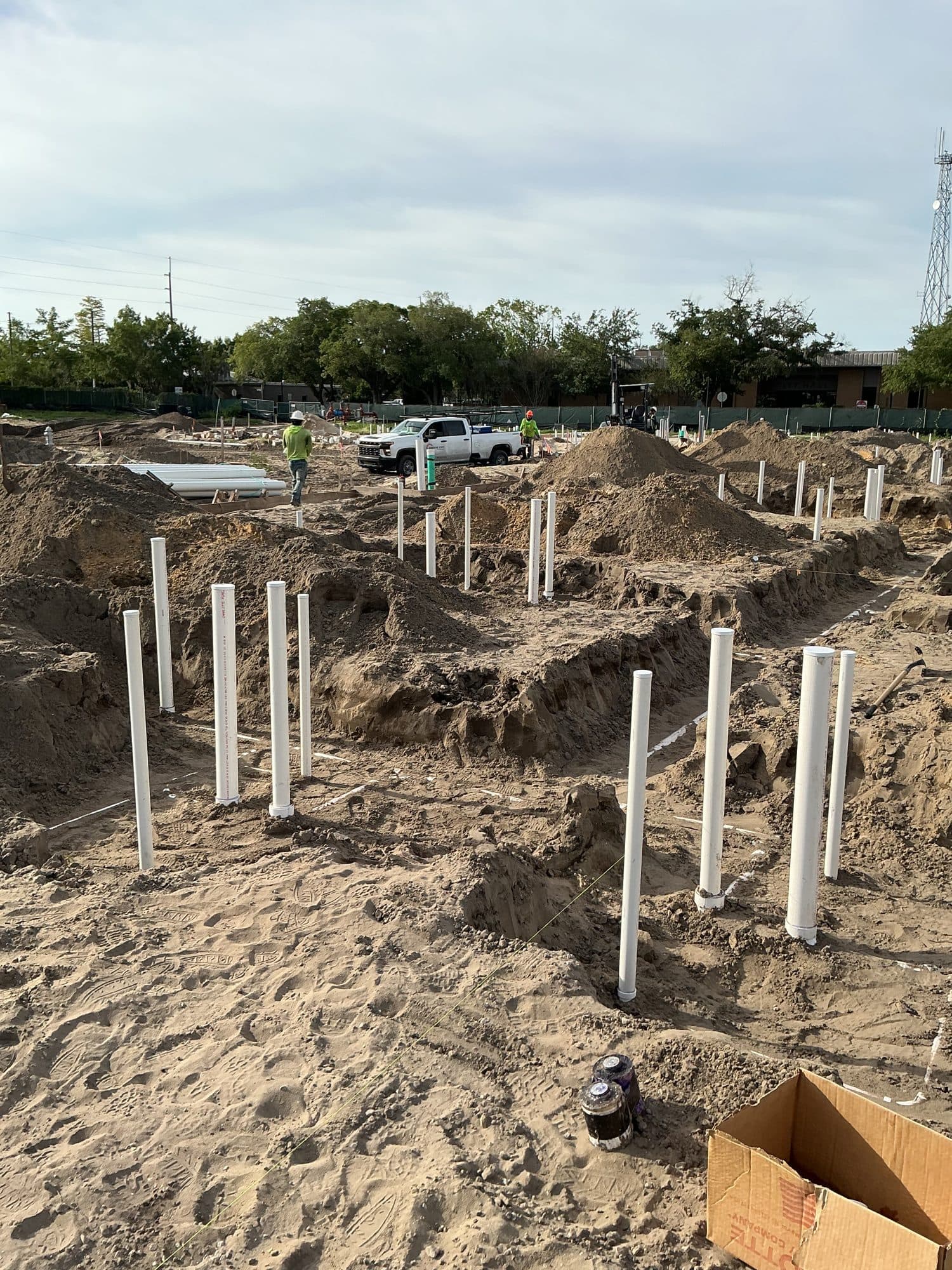 Underground plumbing rough-in with PVC stub-ups at a Sunshine State Plumbing multifamily jobsite